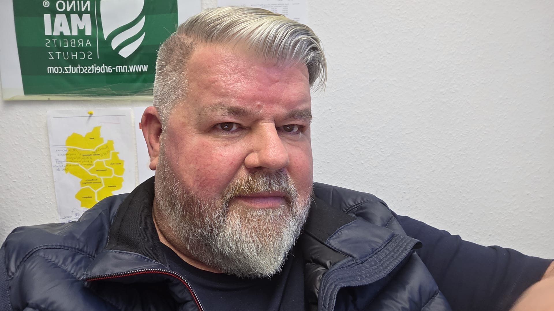 Employee Portrait in an Office Setting Middle-aged man with grey hair and beard in an office environment